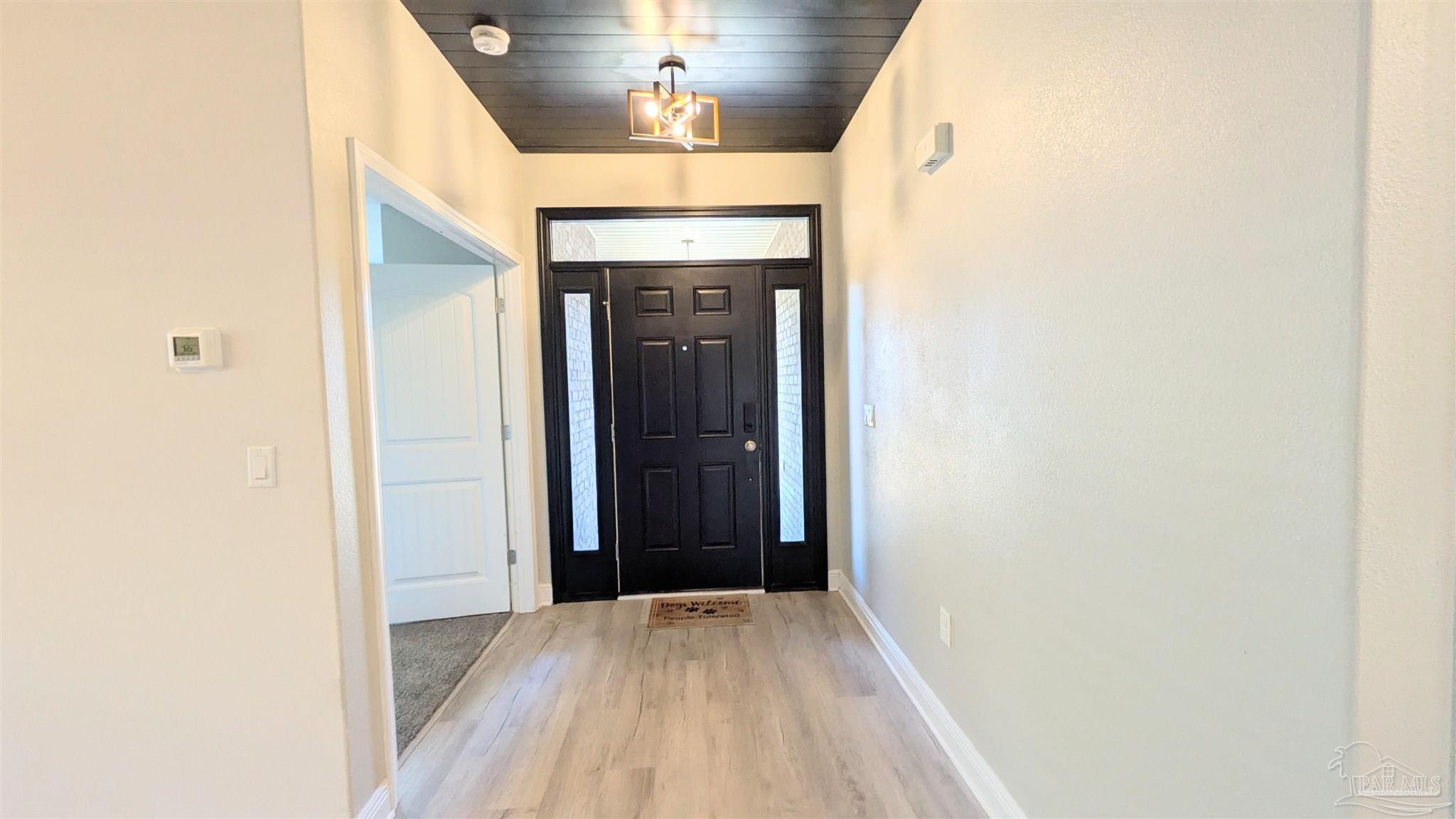 4417 Fiske Street Pace, FL 32571 - Photo 4 of 38 a view of a hallway with wooden floor