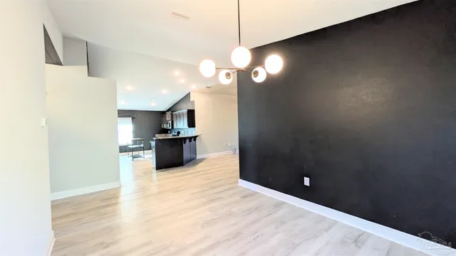 a view of a kitchen with a sink and a large window