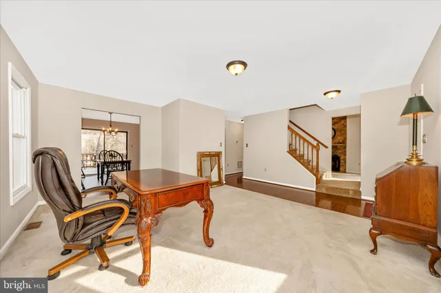 a view of a workspace with furniture and a window