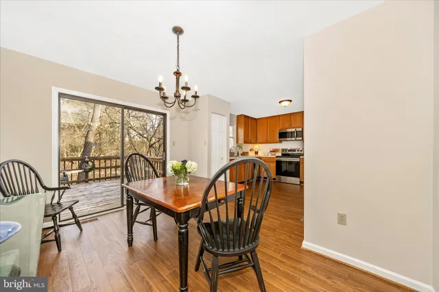 a view of a dining room with furniture wooden floor and chandelier