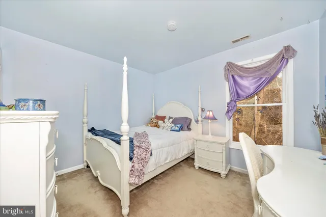 a swimming pool with yard and tree in the background