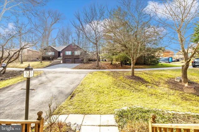an aerial view of a house with a yard swimming pool and green space