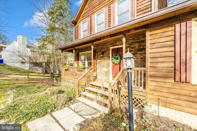 a view of swimming pool with large trees and plants