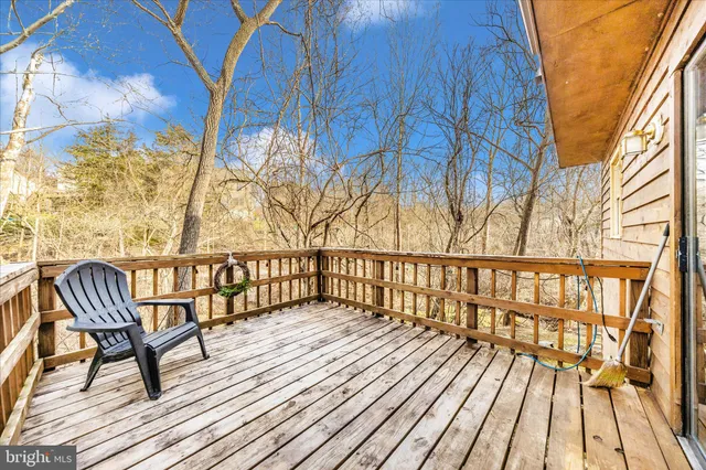 an aerial view of a house with swimming pool large trees and buildings