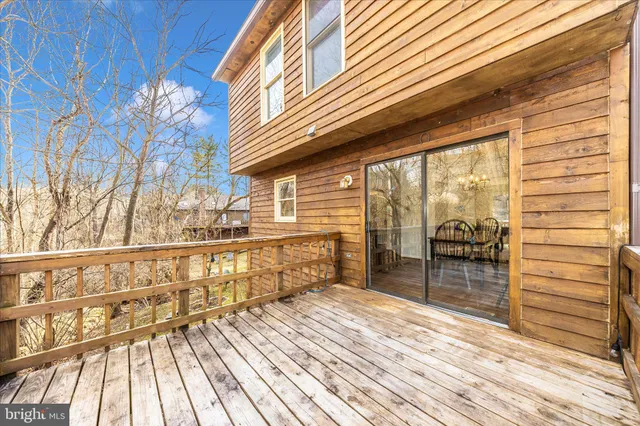 a view of a backyard with lawn chairs