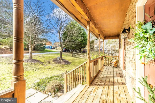 an aerial view of a house with a yard and large tree