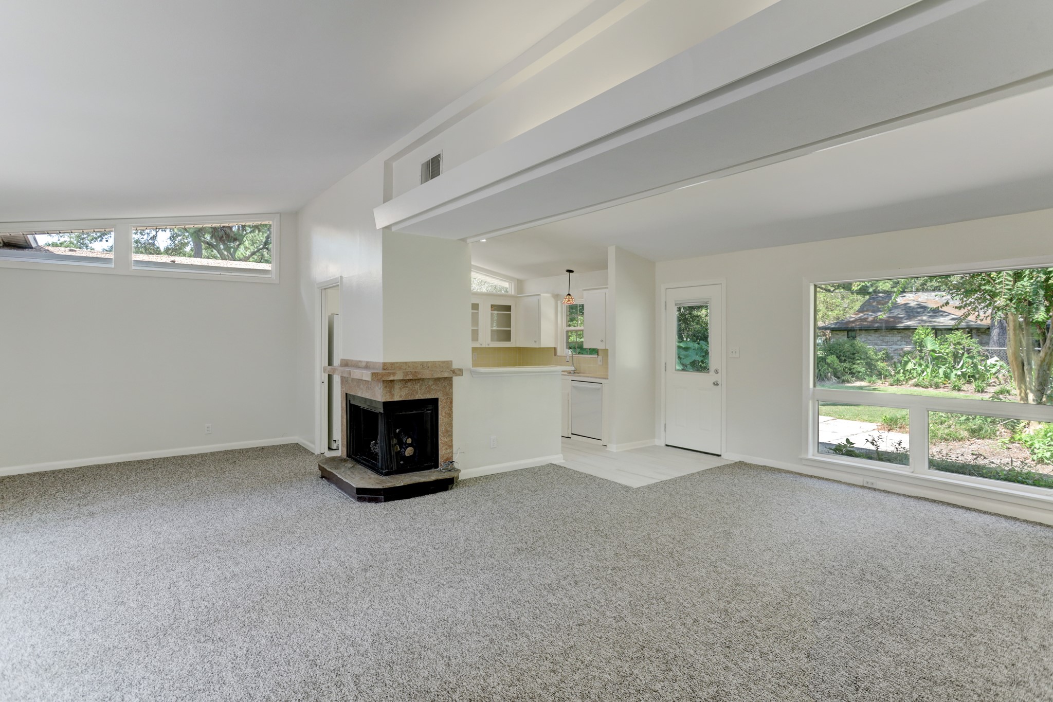 10226 Ivyridge Road Houston, TX 77043 - Photo 5 of 37 a view of an empty room with a fireplace and a window