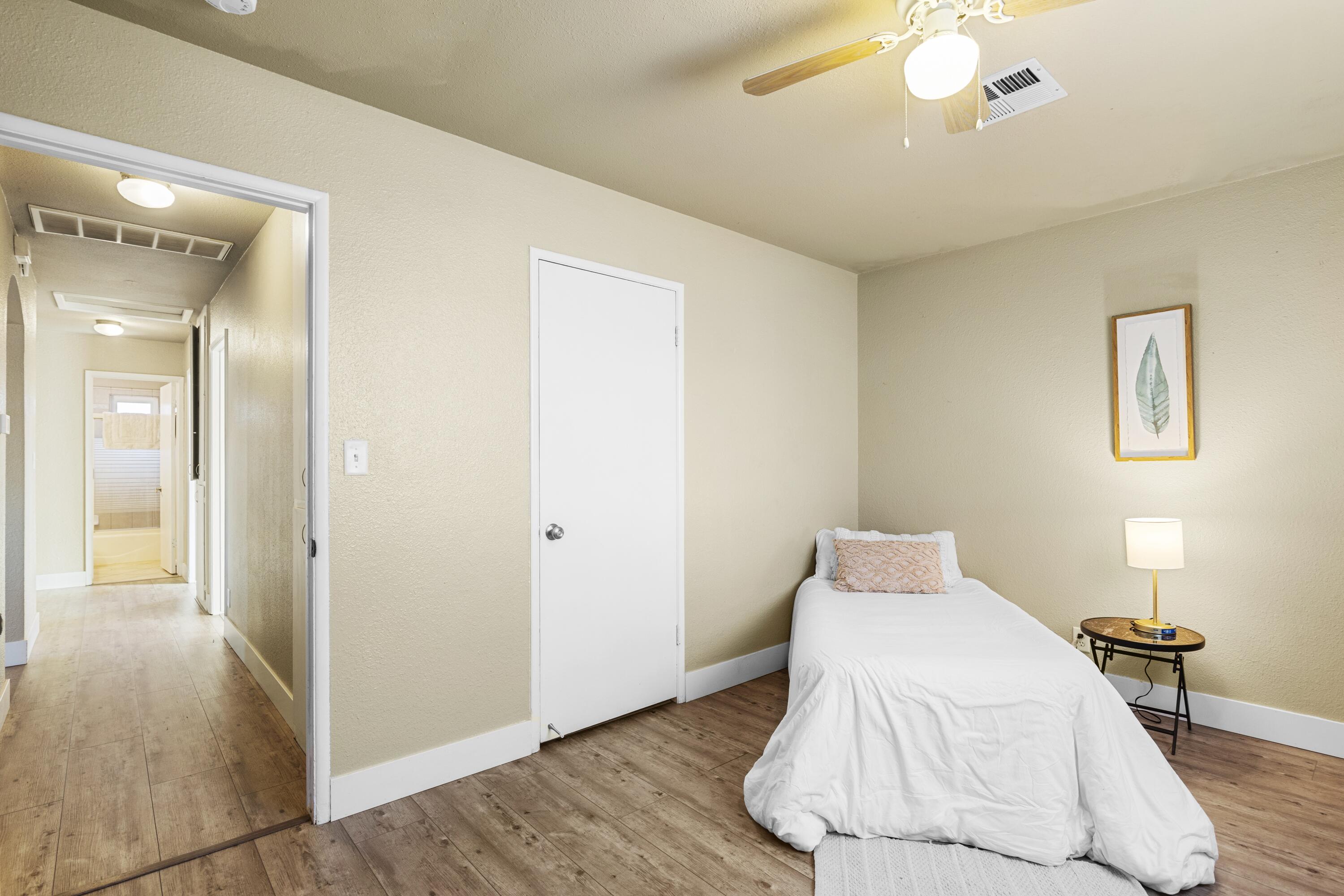 801 Beech Street Tehachapi, CA 93561 - Photo 16 of 24 a bedroom with a bed and a chandelier