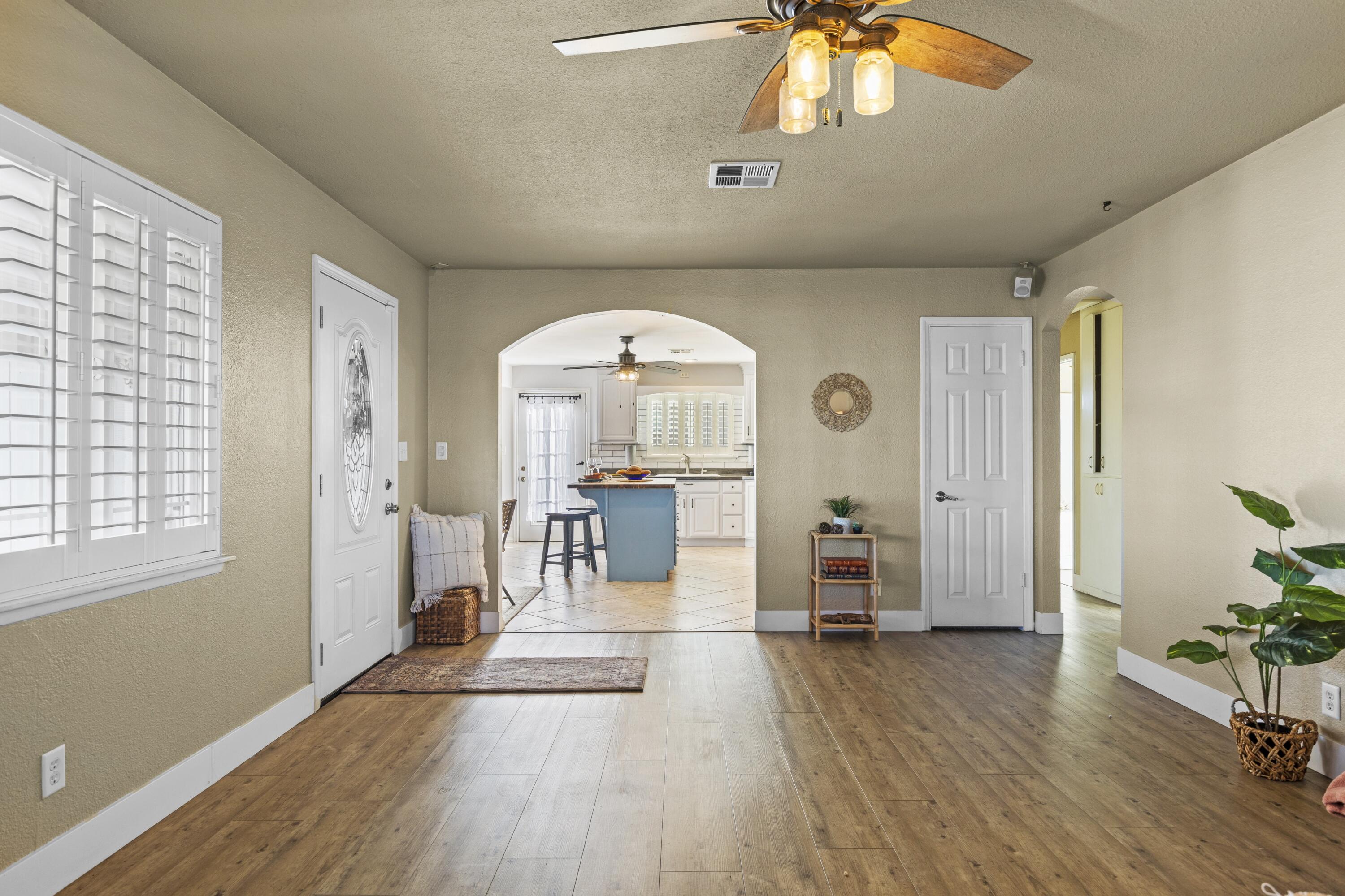 801 Beech Street Tehachapi, CA 93561 - Photo 9 of 24 wooden floor in an empty room with a window