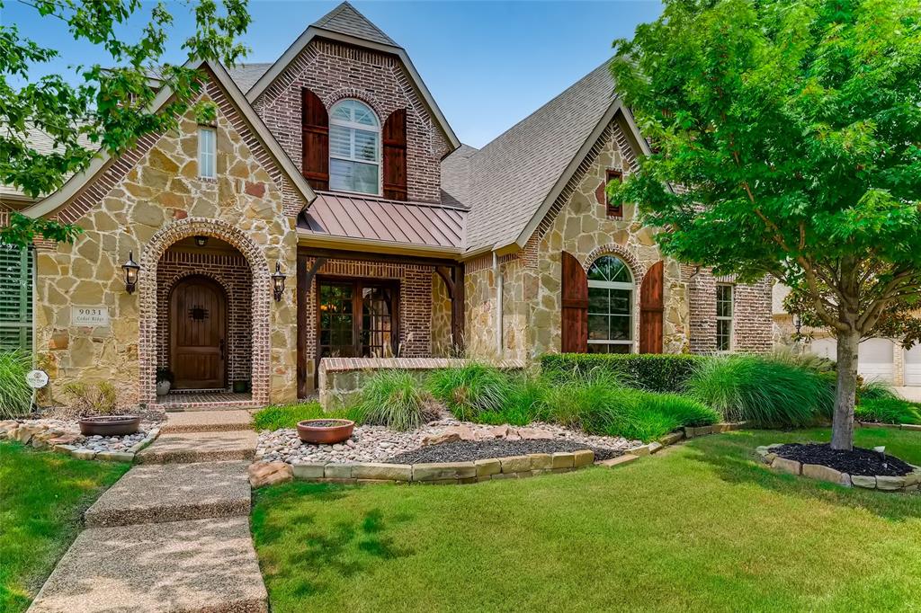 9031 Cedar Ridge Lantana, TX 76226 - Photo 1 of 1 a front view of a house with a garden and plants