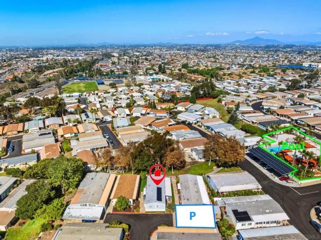 a front view of a house with a tree