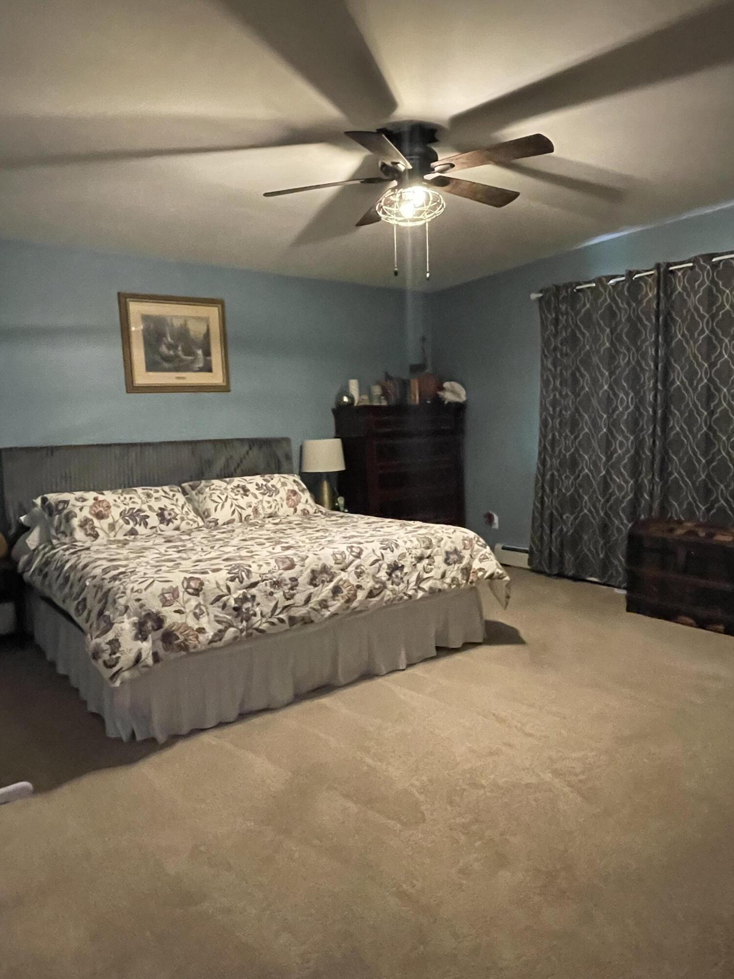 2122 Woodthrush Court Bushkill, PA 18324 - Photo 14 of 29 a bed sitting in a bedroom and chandelier