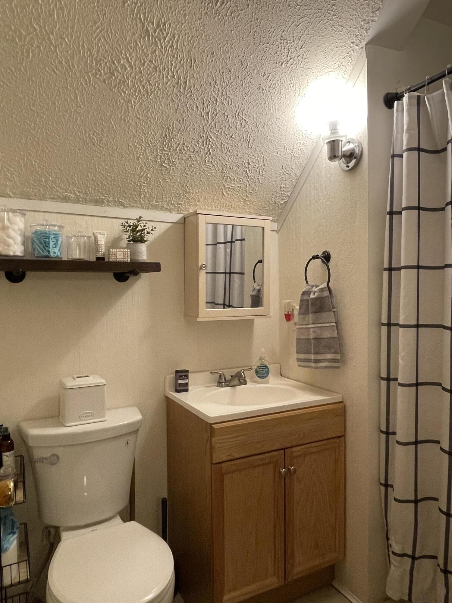 2122 Woodthrush Court Bushkill, PA 18324 - Photo 24 of 29 a bathroom with a toilet sink and mirror