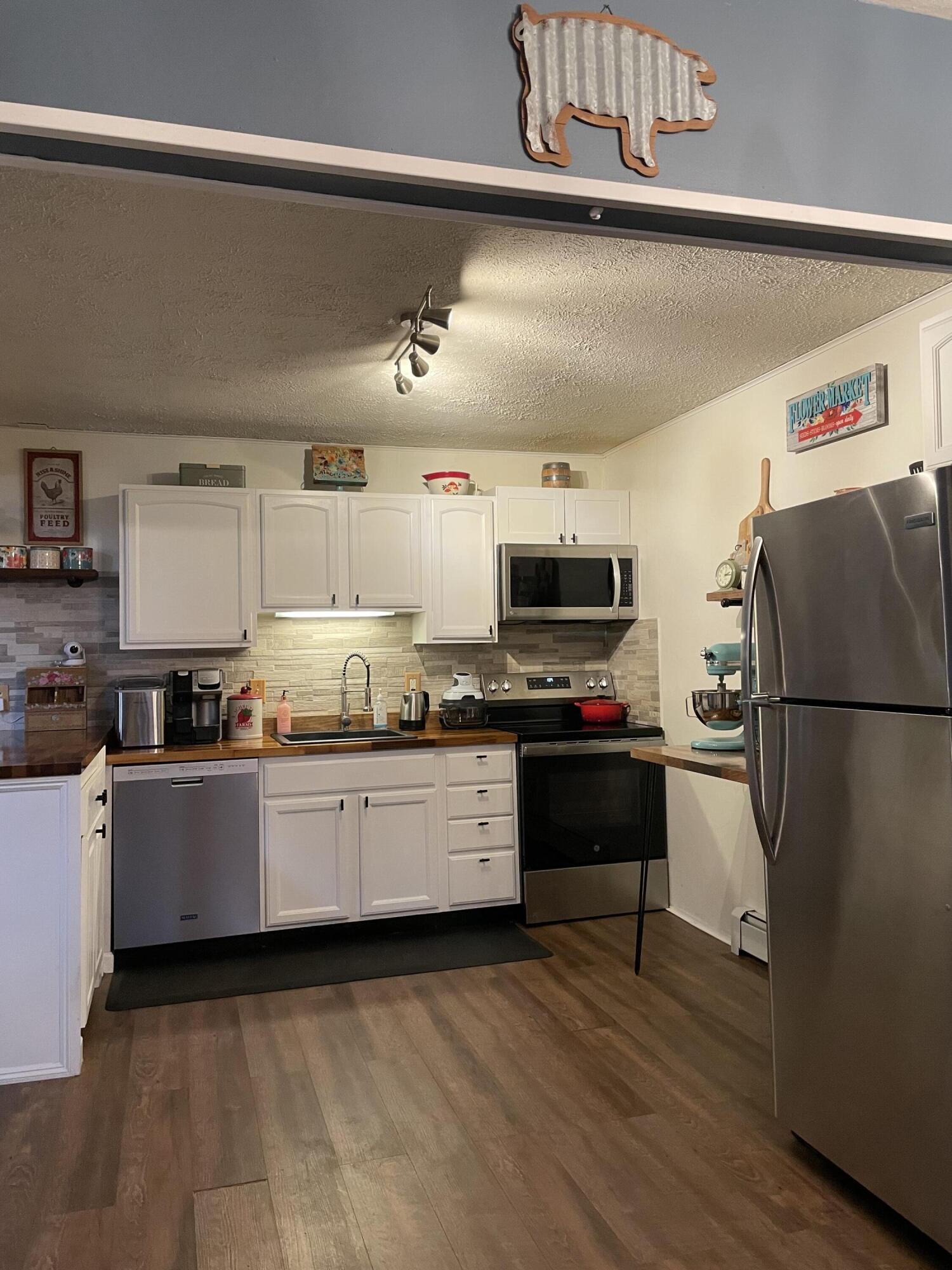 2122 Woodthrush Court Bushkill, PA 18324 - Photo 8 of 29 a kitchen with stainless steel appliances a refrigerator and a stove top oven