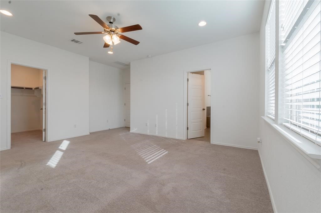 1333 Terrace View Drive Georgetown, TX 78628 - Photo 28 of 35 A well-lit bedroom features plush carpeting and convenient walk-in closet access.