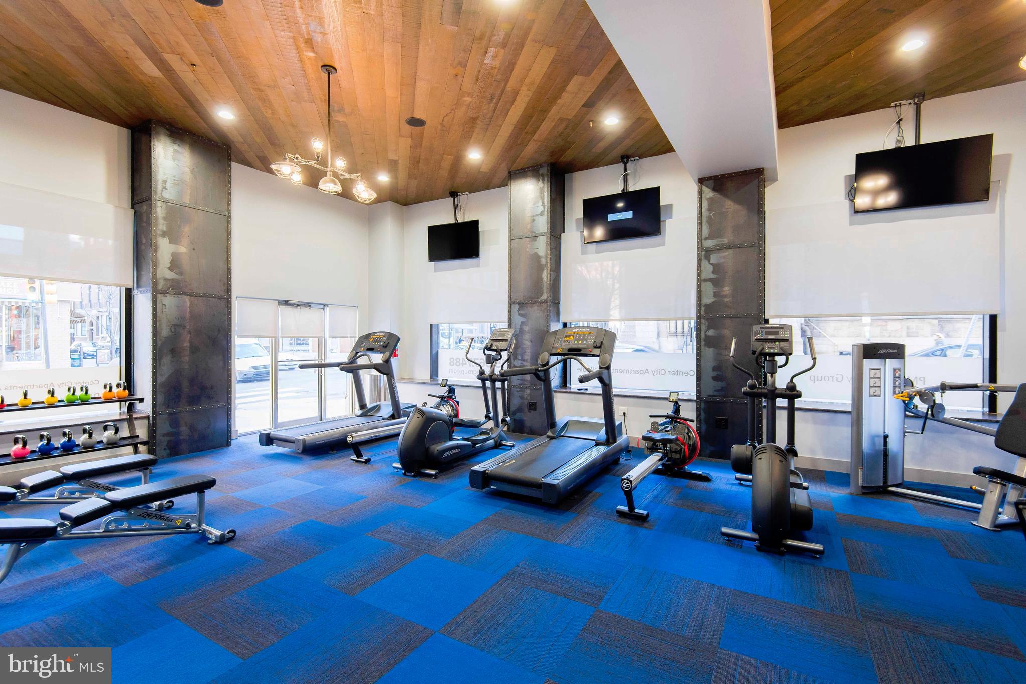 2100-02 Walnut Street, Unit 7G Philadelphia, PA 19103 - Photo 6 of 20 a view of a livingroom with workspace and a ceiling fan
