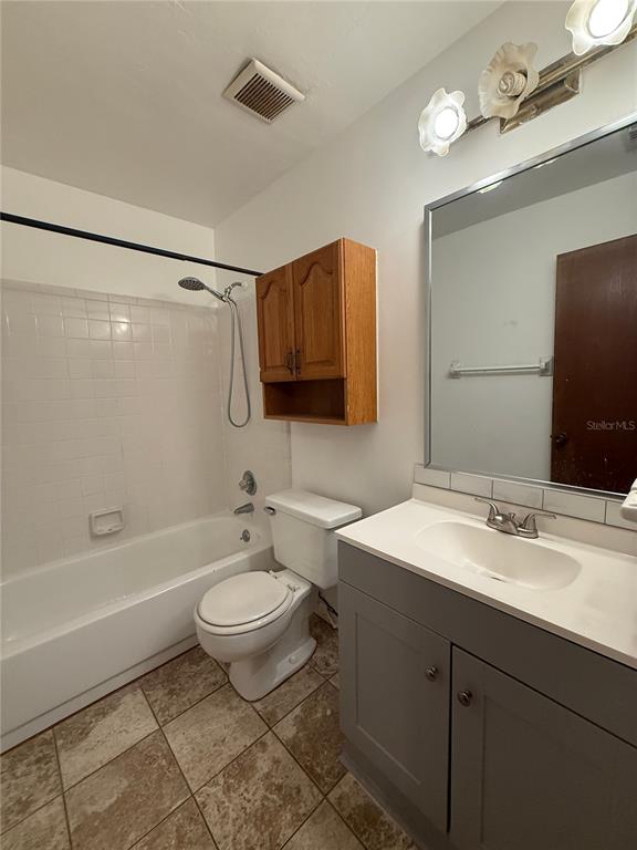 7200 Southwest 8th Avenue, Unit T128 Gainesville, FL 32607 - Photo 32 of 38 a bathroom with a sink toilet a mirror and shower