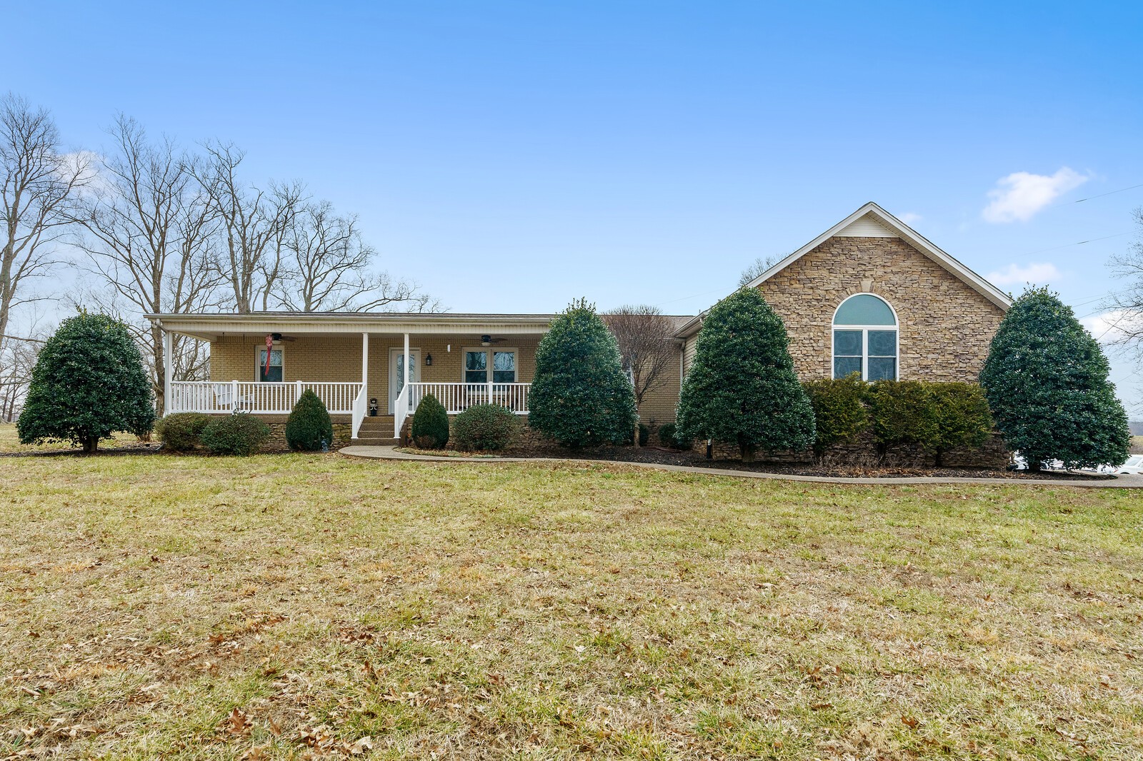 415 Woodruff Road Adams, TN 37010 - Photo 1 of 47 a front view of a house with yard and green space
