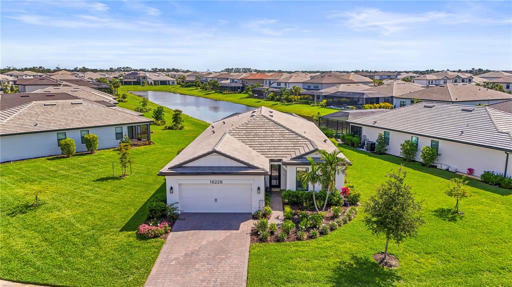 an aerial view of residential houses with outdoor space and swimming pool