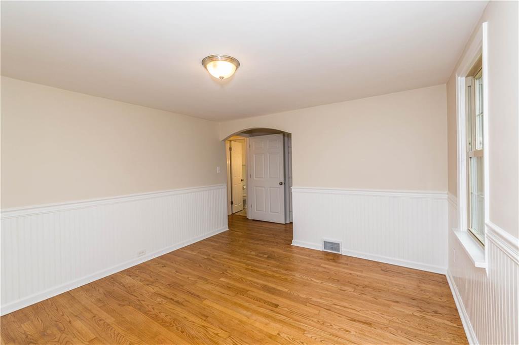 500 Friel Road Baden, PA 15005 - Photo 12 of 24 Retreat to this massive first floor master suite, complete with hardwood floors, white wainscoting, new ceiling light, windows, walk-in closet, and full master bath.