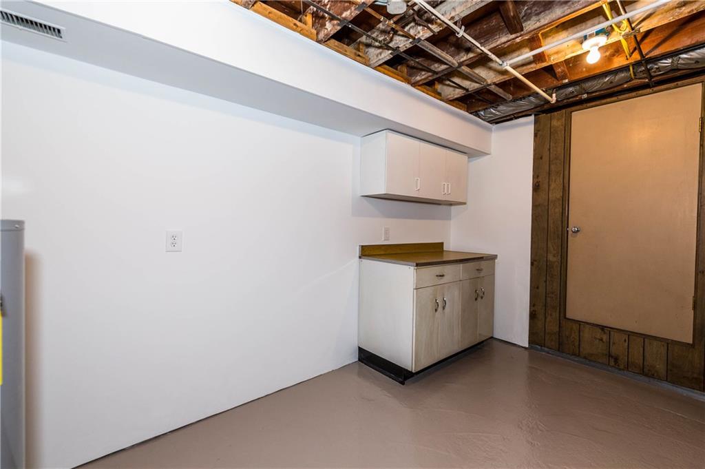 500 Friel Road Baden, PA 15005 - Photo 23 of 24 Laundry room with counter space to fold clothes and storage cabinets. (The tan door opens to a large, cold-storage area.)