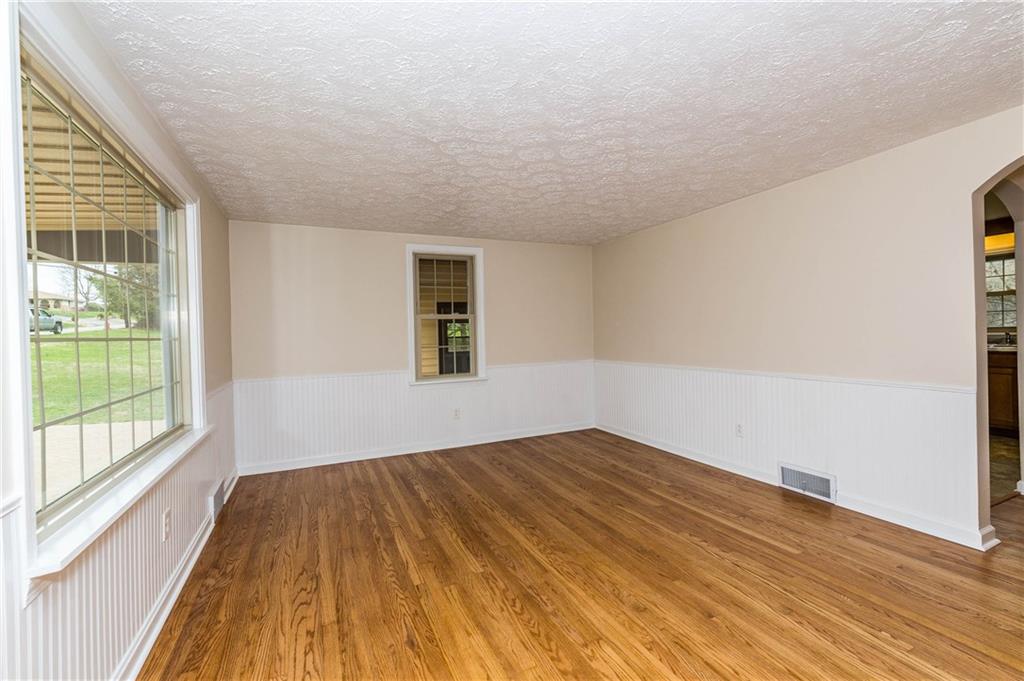500 Friel Road Baden, PA 15005 - Photo 4 of 24 Another view of the living room/family room with hardwood floors and white wainscoting. Lovely!