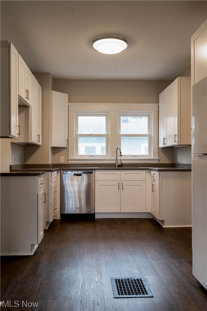 170 Avon Belden Road Avon Lake, OH 44012 - Photo 5 of 18 Kitchen with white fridge, sink, stainless steel dishwasher, dark hardwood / wood-style floors, and white cabinetry