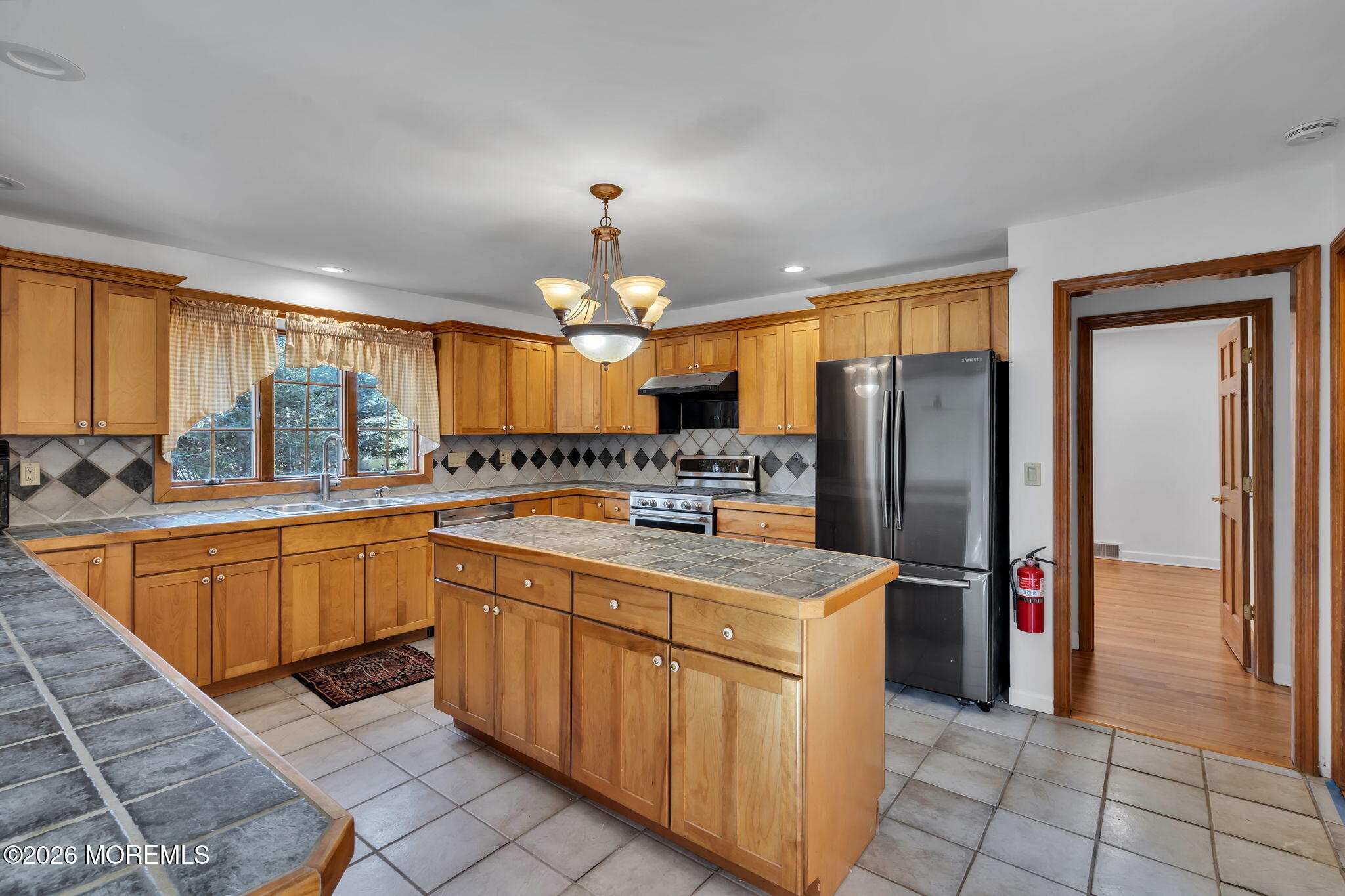53 Montrose Road Colts Neck, NJ 07722 - Photo 11 of 43 a kitchen with stainless steel appliances a sink counter space cabinets and a large window