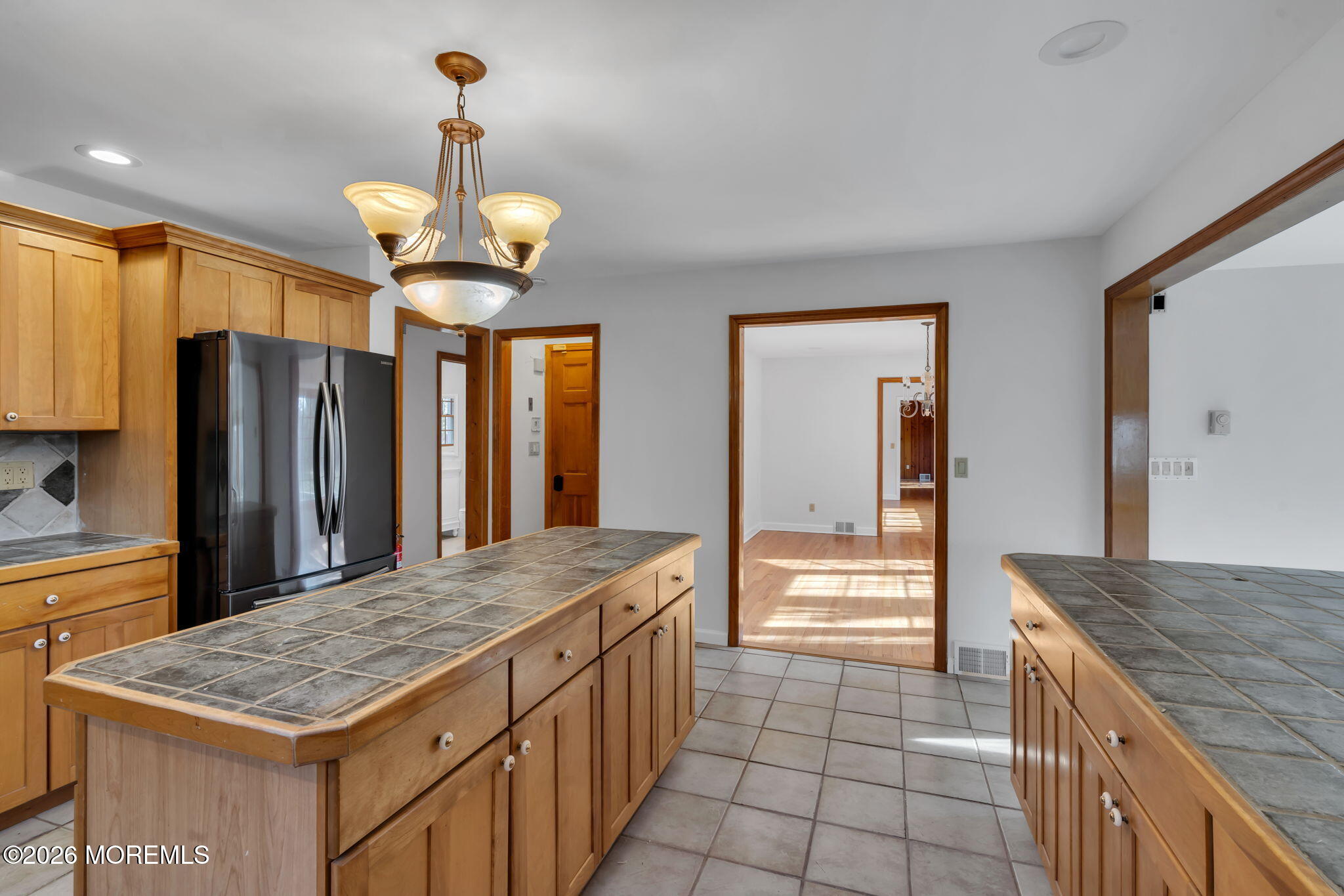 53 Montrose Road Colts Neck, NJ 07722 - Photo 12 of 43 a kitchen with kitchen island granite countertop a stove and a refrigerator