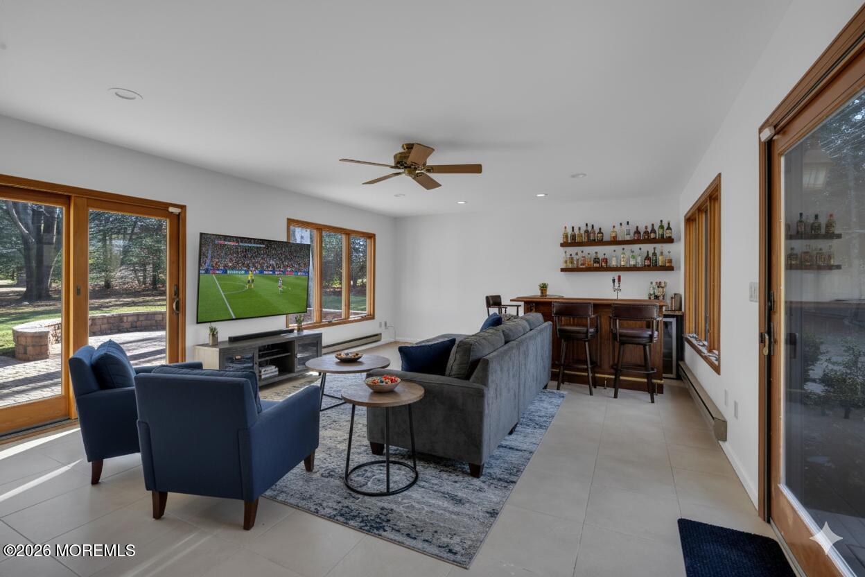 53 Montrose Road Colts Neck, NJ 07722 - Photo 16 of 43 a living room with furniture a flat screen tv and a large window