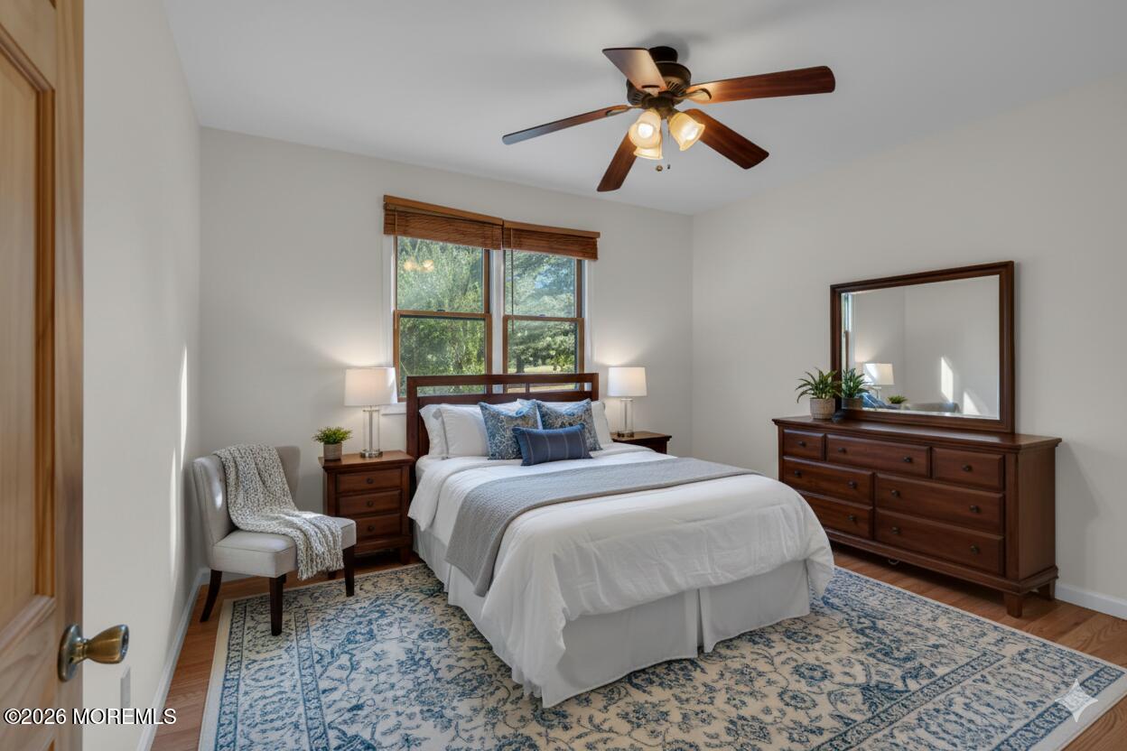 53 Montrose Road Colts Neck, NJ 07722 - Photo 22 of 43 a bedroom with a bed and wooden floor