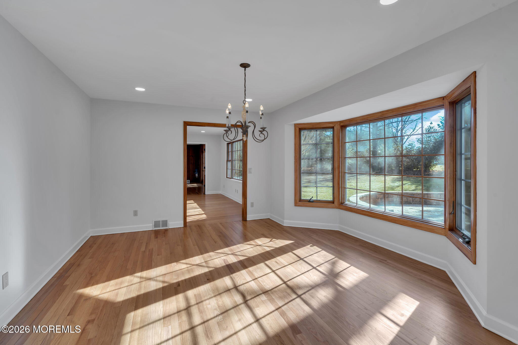 53 Montrose Road Colts Neck, NJ 07722 - Photo 9 of 43 a spacious bedroom with a large bed and a chandelier