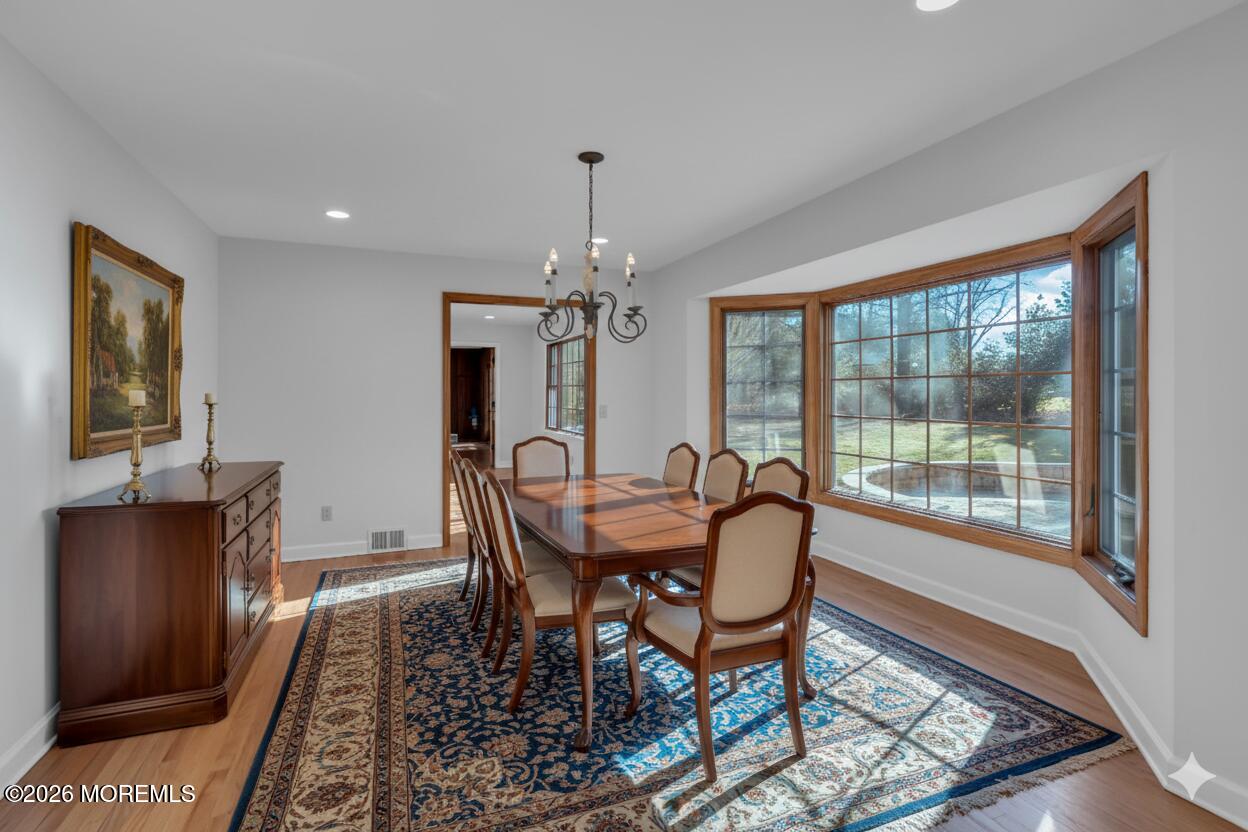 53 Montrose Road Colts Neck, NJ 07722 - Photo 10 of 43 a dining room with furniture a chandelier and wooden floor