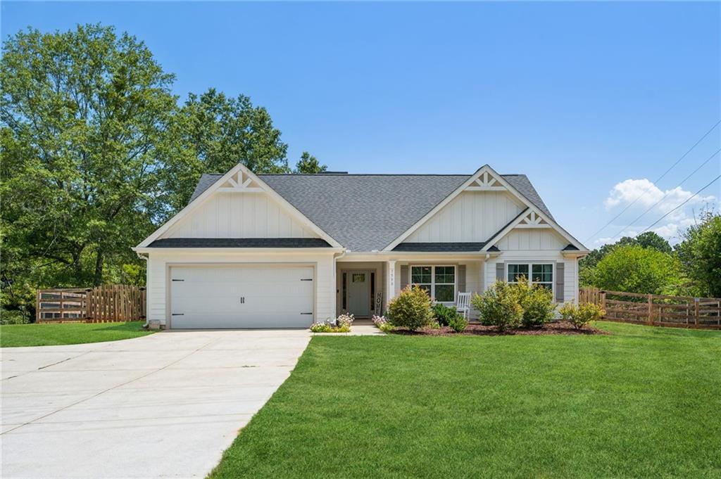 7590 Little Mill Road Cumming, GA 30041 - Photo 1 of 1 a view of a house with a big yard plants and large trees