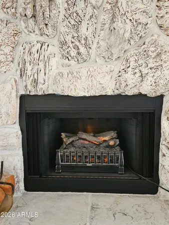 a black and white photo of a fireplace