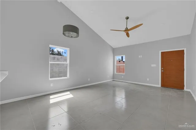 an empty room with windows and closet