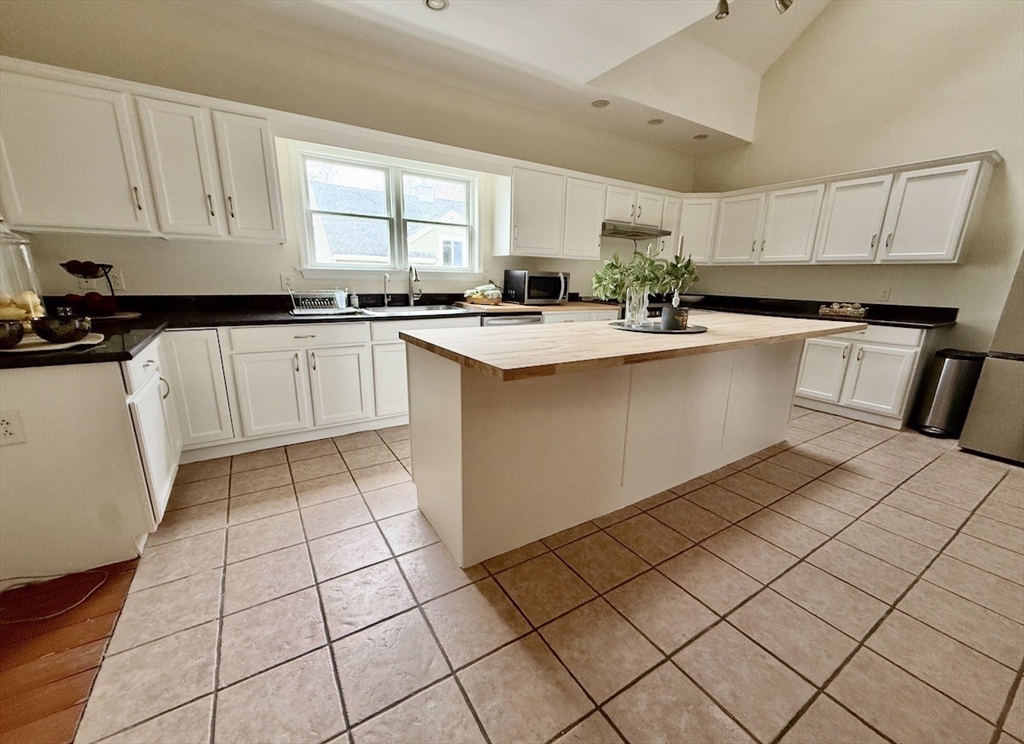 25 Pleasant Street Nahant, MA 01908 - Photo 12 of 39 a kitchen with stainless steel appliances a sink window and cabinets