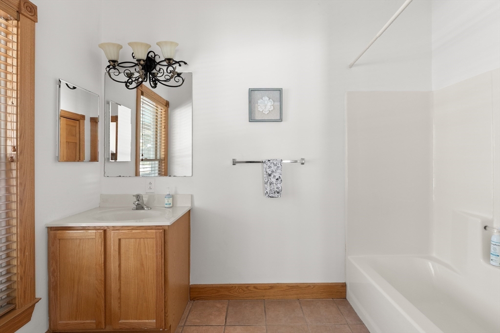 25 Pleasant Street Nahant, MA 01908 - Photo 22 of 39 a bathroom with a sink a toilet and bathtub