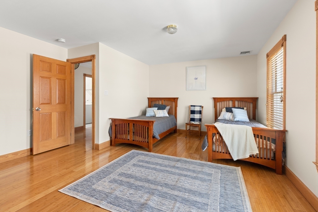 25 Pleasant Street Nahant, MA 01908 - Photo 23 of 39 a bedroom with two beds and wooden floor