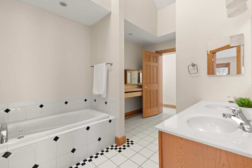 25 Pleasant Street Nahant, MA 01908 - Photo 31 of 39 a bathroom with a sink double vanity and a tub