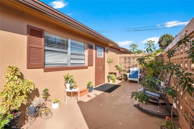 a backyard of a house with outdoor seating