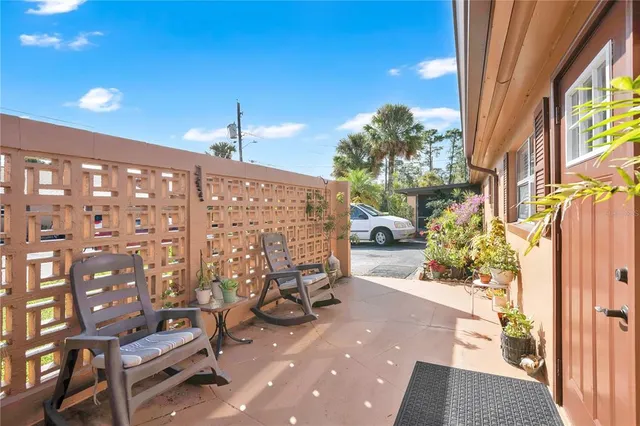 a view of a patio with table and chairs and potted plants