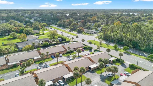 an aerial view of residential houses with outdoor space