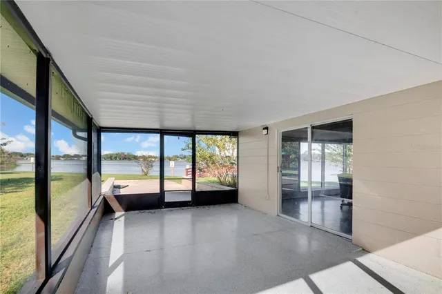 an empty room with large windows