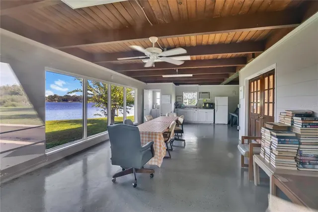 a dining room with wooden floor table and chairs