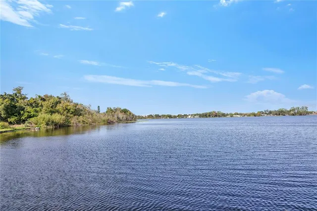 an outdoor sitting area with swimming pool and trees
