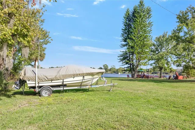 a backyard of a house with table and chairs