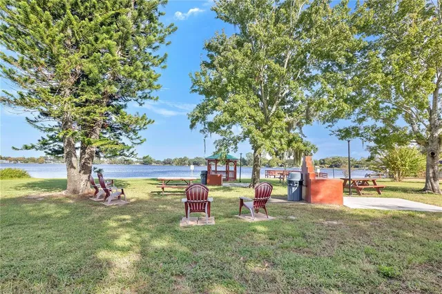 a backyard of a house with table and chairs