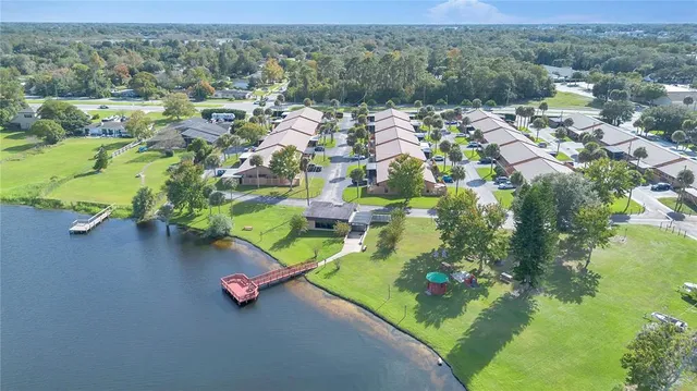 a view of a lake with a house swimming pool and outdoor space