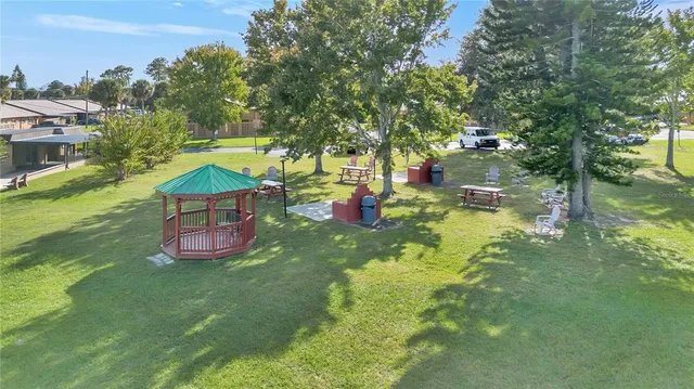 an outdoor space with swimming pool and green space